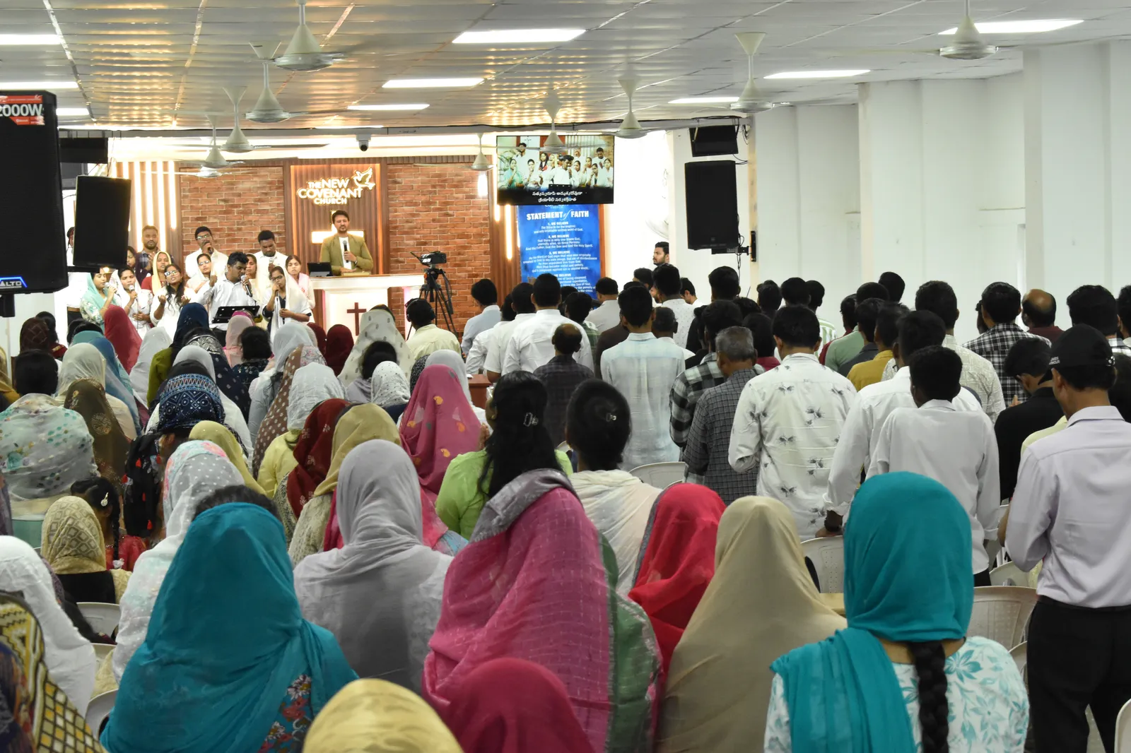 Congregation raising hands in praise